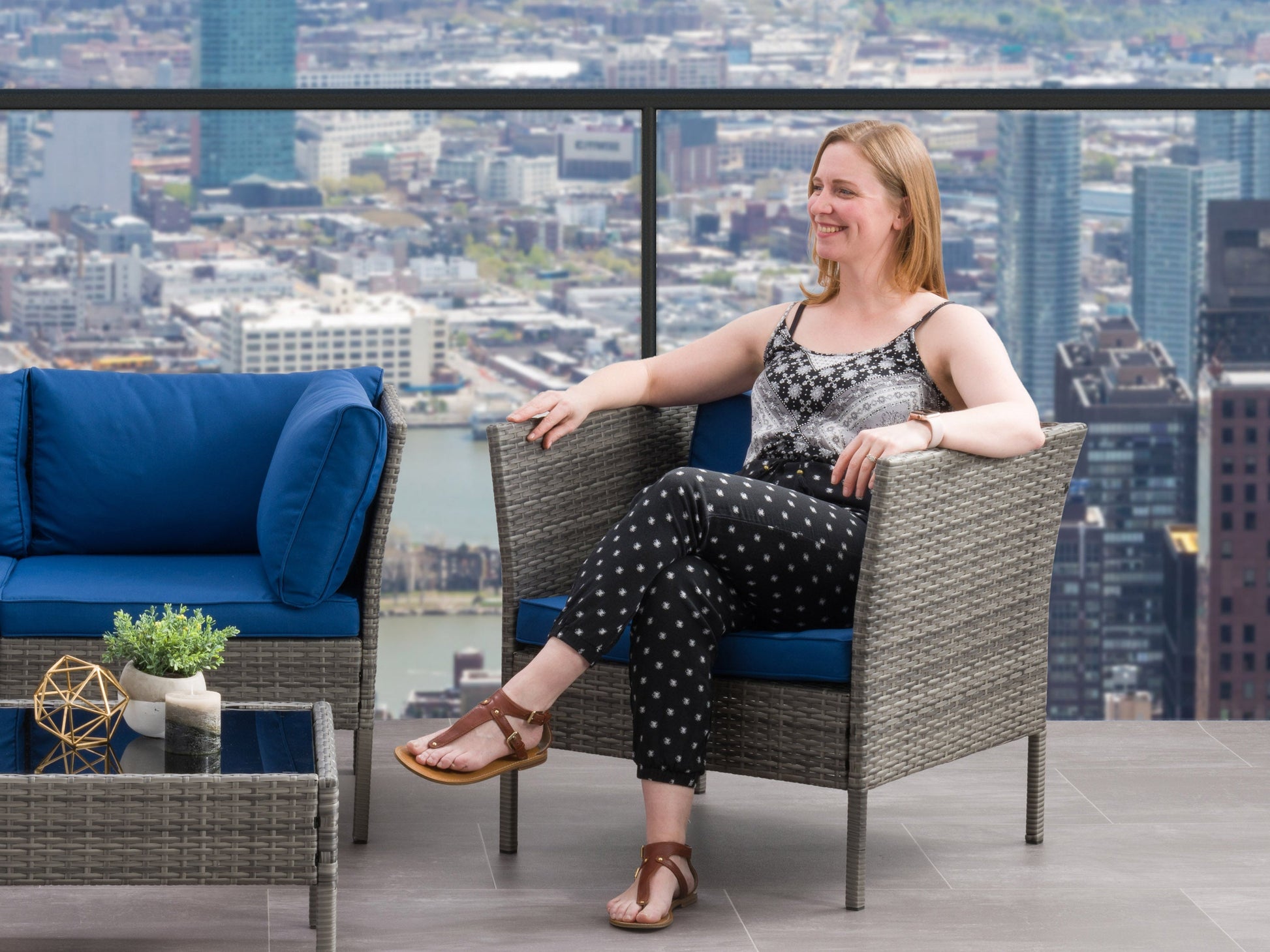 Grey and blue patio armchair with cushioned seat, wooden frame, and modern design.