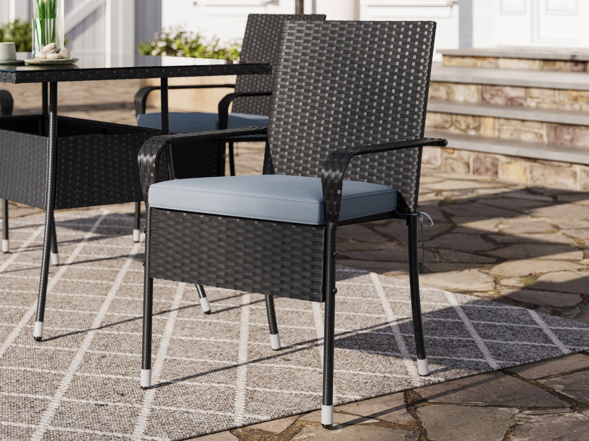 5-piece patio dining set with grey cushions, black metal frame, and wooden tabletop, perfect for outdoor dining.