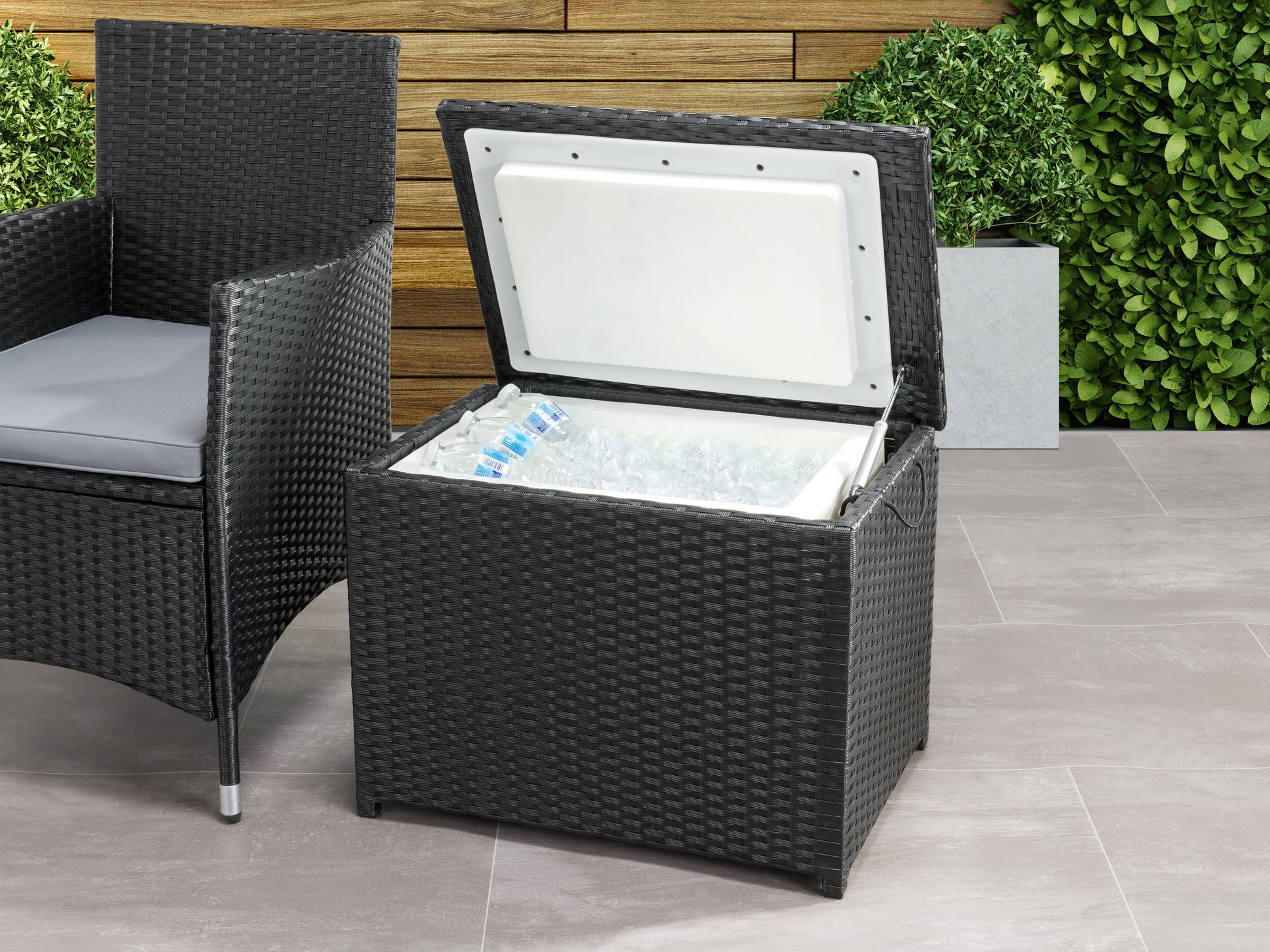 Outdoor cooler table with dark brown wicker design, flat top surface, and built-in storage compartment. Ideal for patio use, it combines functionality with stylish outdoor furniture aesthetics.