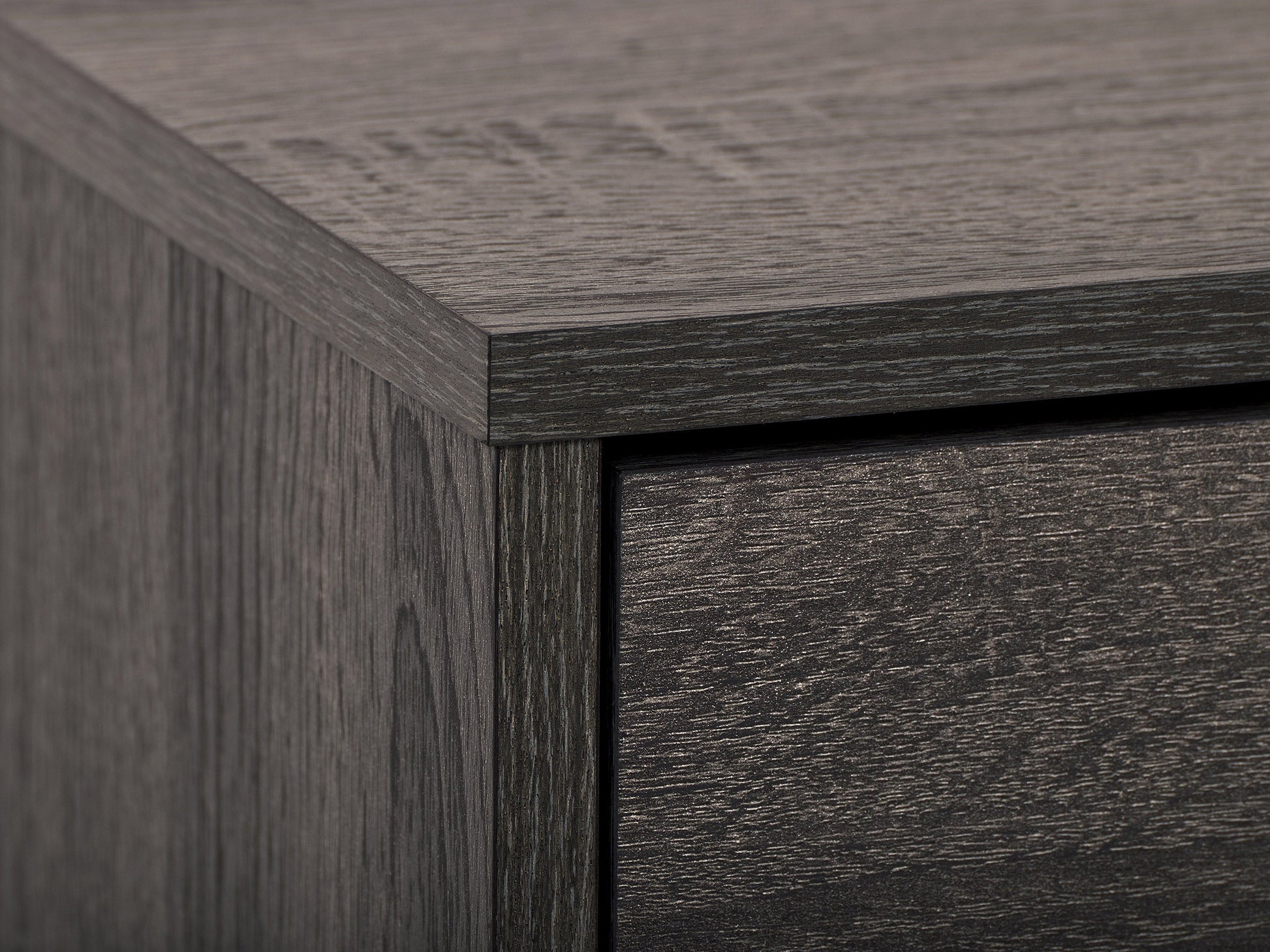 Dark grey TV stand with cabinet storage, fits TVs up to 85 inches, sleek design, sturdy construction.