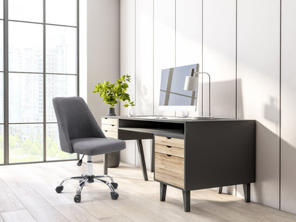 Dark grey armless task chair with ergonomic design, mesh backrest, and adjustable height for office use.