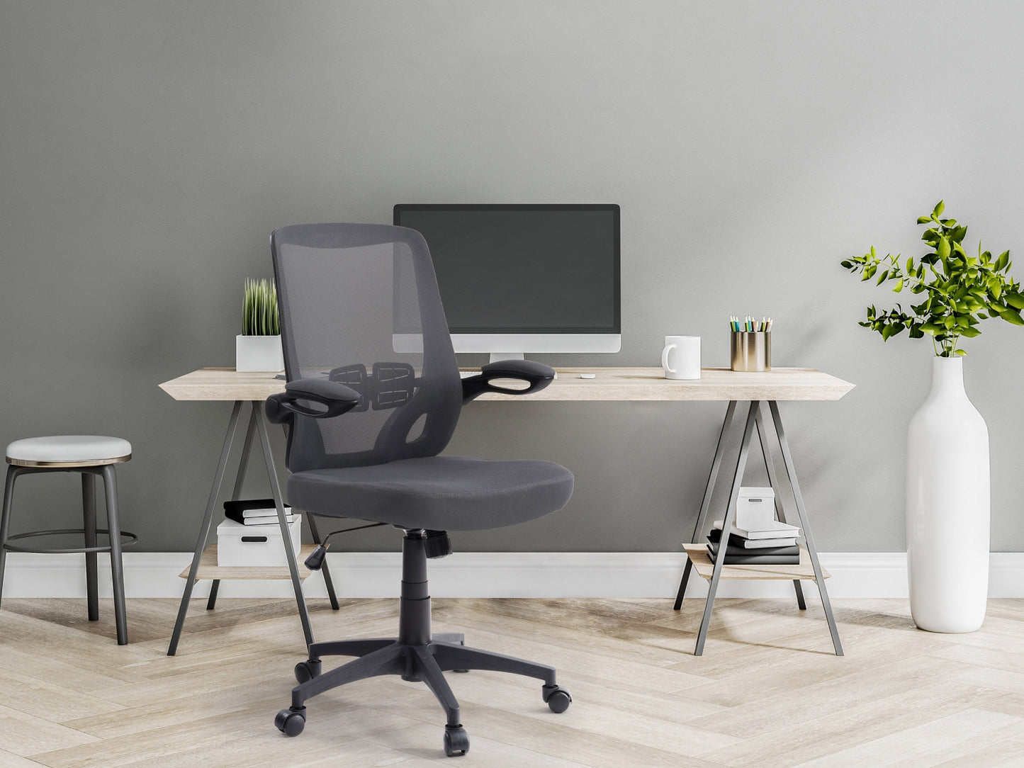 Grey mesh office chair with ergonomic design, adjustable height, and lumbar support for modern office spaces.