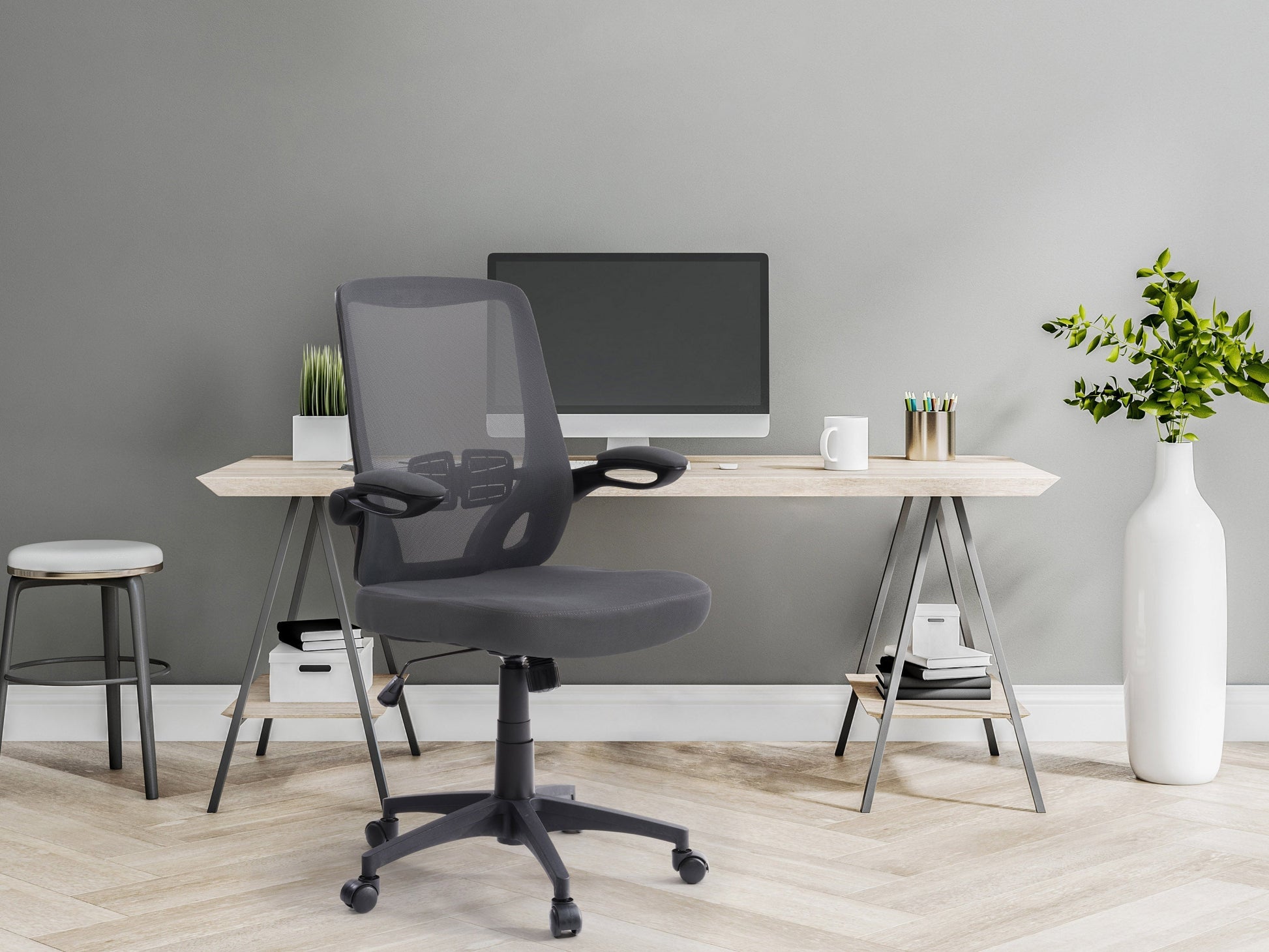 Grey mesh office chair with ergonomic design, adjustable height, and lumbar support for modern office spaces.