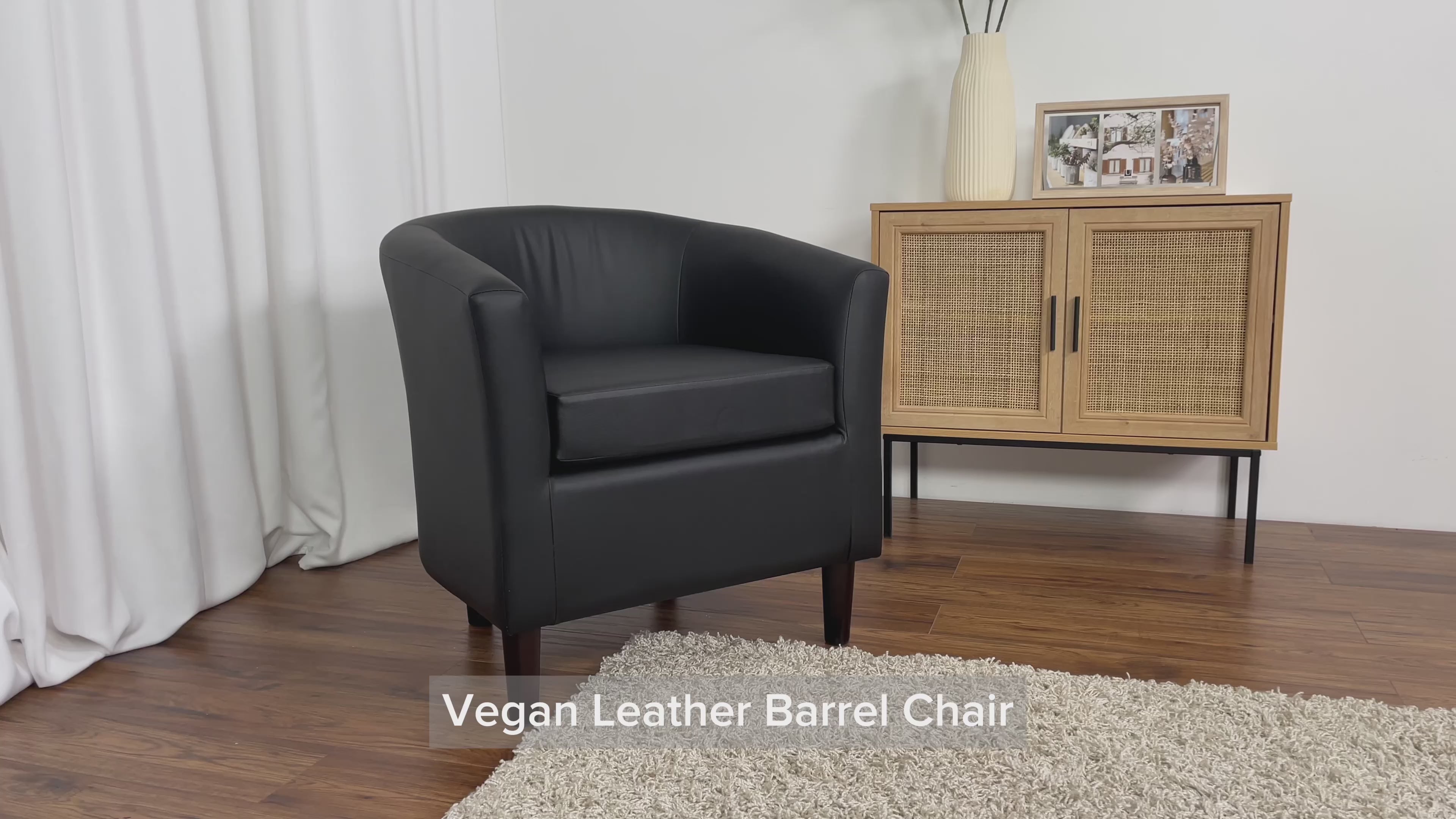Load video: Sasha Black Vegan Leather Barrel Chair Product Video