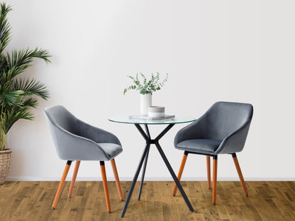 Modern glass bistro dining table with round clear glass top, sleek wooden legs, and minimalist design, perfect for contemporary dining rooms.