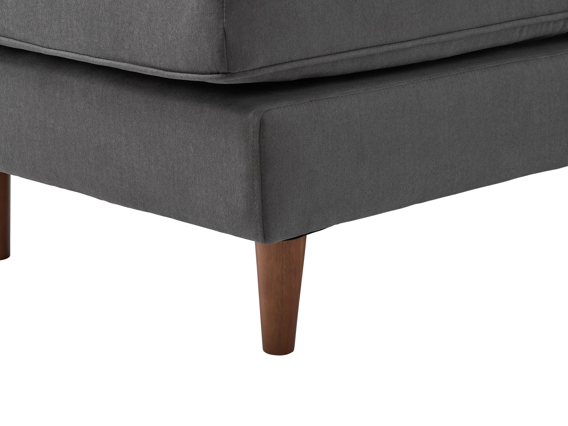 Dark gray sectional sofa with tufted cushions, modern L-shaped design, and sturdy metal legs. Upholstered in soft fabric, featuring a spacious chaise lounge and sleek armrests, perfect for contemporary living rooms.