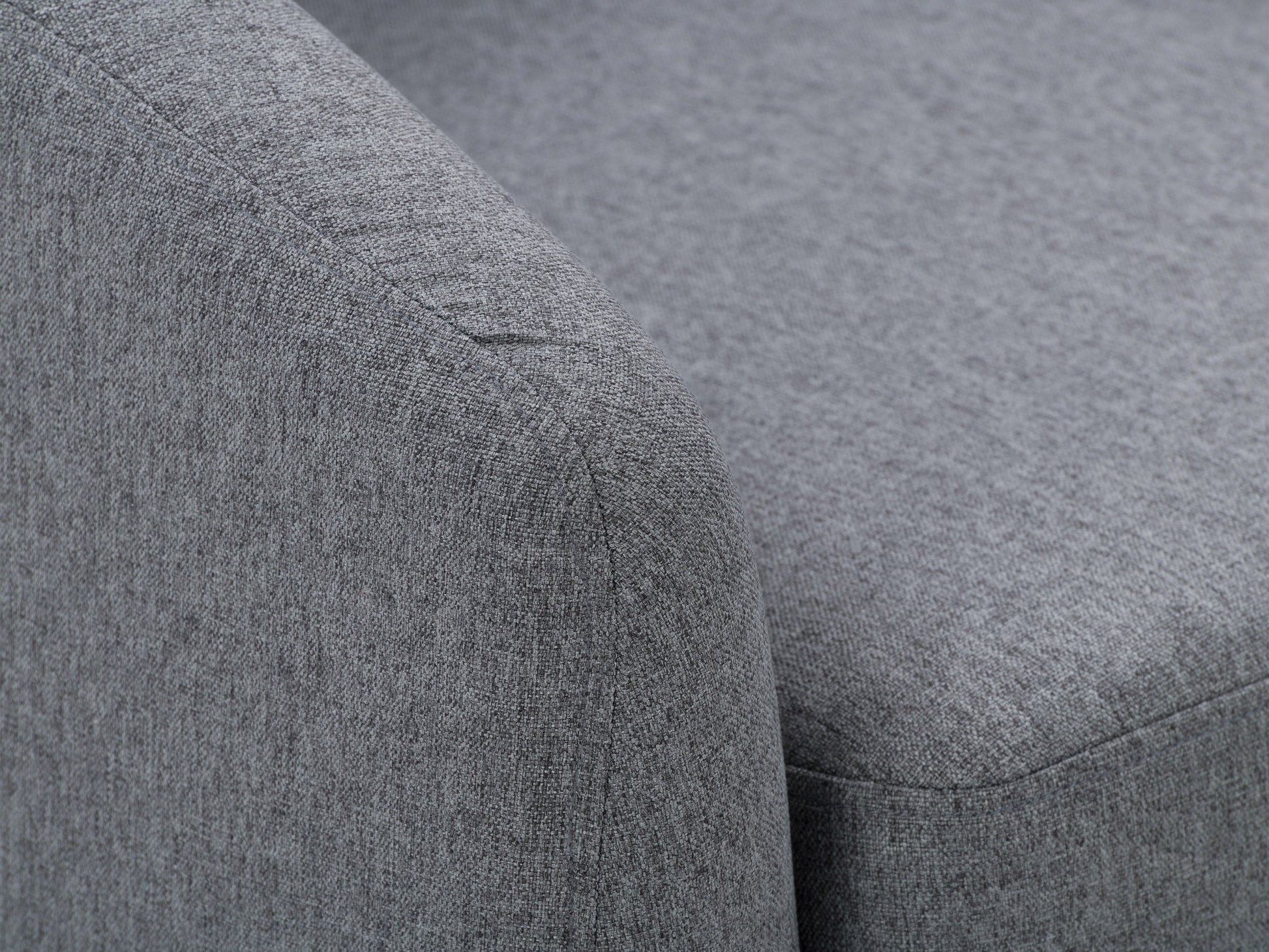 Modern grey fabric tub chair with wooden legs, featuring a curved backrest and cushioned seat for comfort, perfect for living rooms or offices.