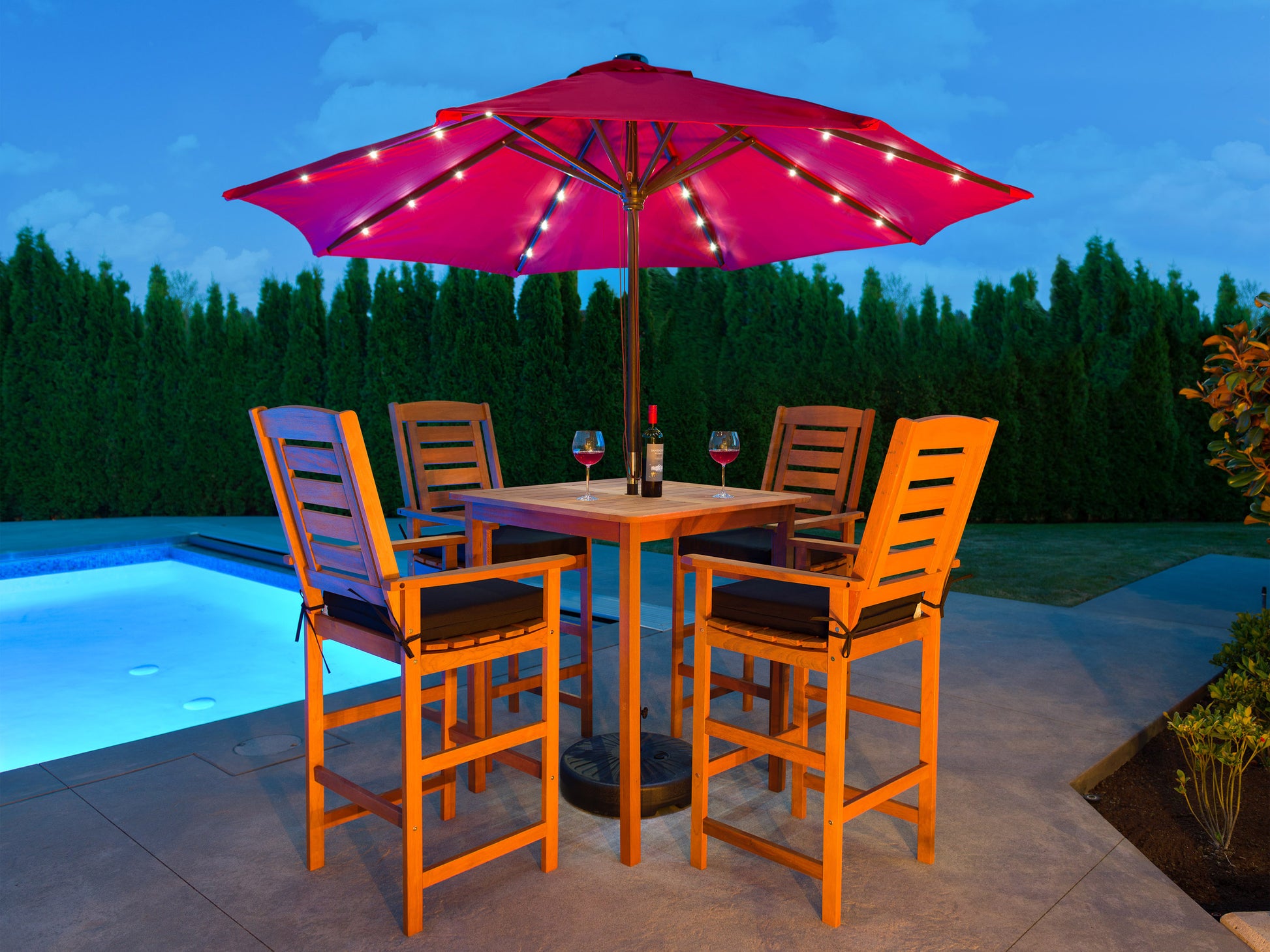 Outdoor patio bar set with two cushioned stools and a glass-top bar table, featuring a black metal frame and beige wicker design, perfect for garden or backyard entertaining.