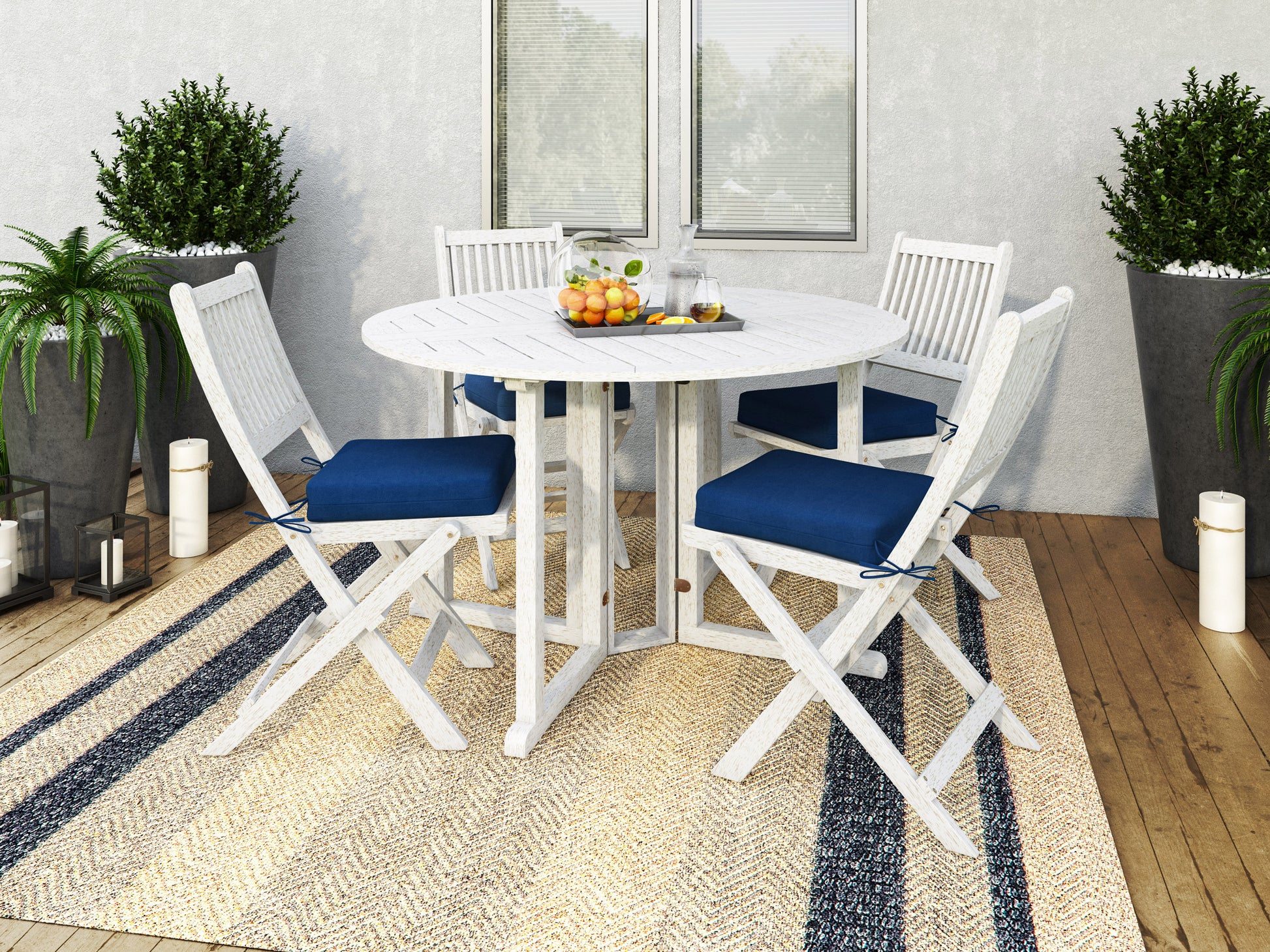 Outdoor patio dining set with dark brown wicker chairs, beige cushions, and a rectangular glass-top table, placed on a wooden deck with green plants in the background.