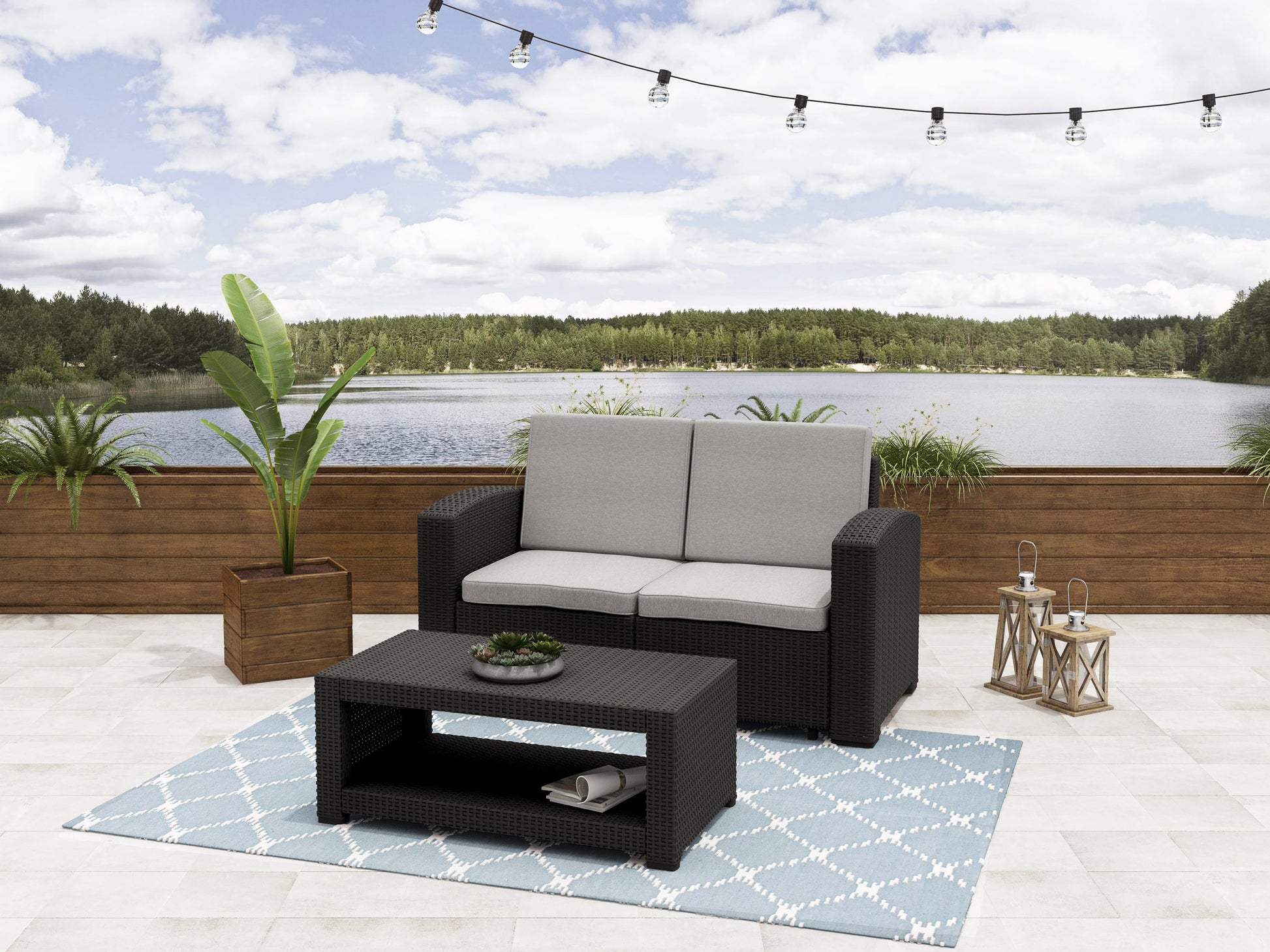 Gray wicker patio conversation set with cushions, featuring a loveseat, two armchairs, and a glass-top coffee table, perfect for outdoor lounging and entertaining.
