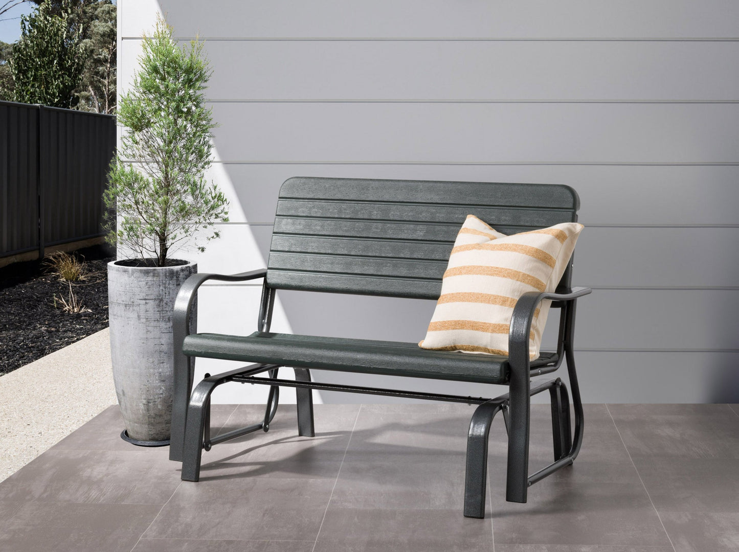 Modern gray patio bench with comfortable cushions, sleek aluminum frame, and wooden armrests, placed in a lush garden setting. Ideal for outdoor seating, combining style and durability for a contemporary look.