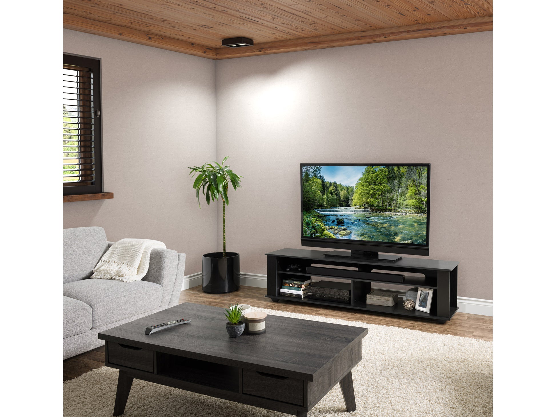 Black TV stand with sleek design, supporting TVs up to 85 inches. Features open shelving for media equipment, cable management, and a modern finish. Perfect for contemporary living rooms or entertainment spaces.